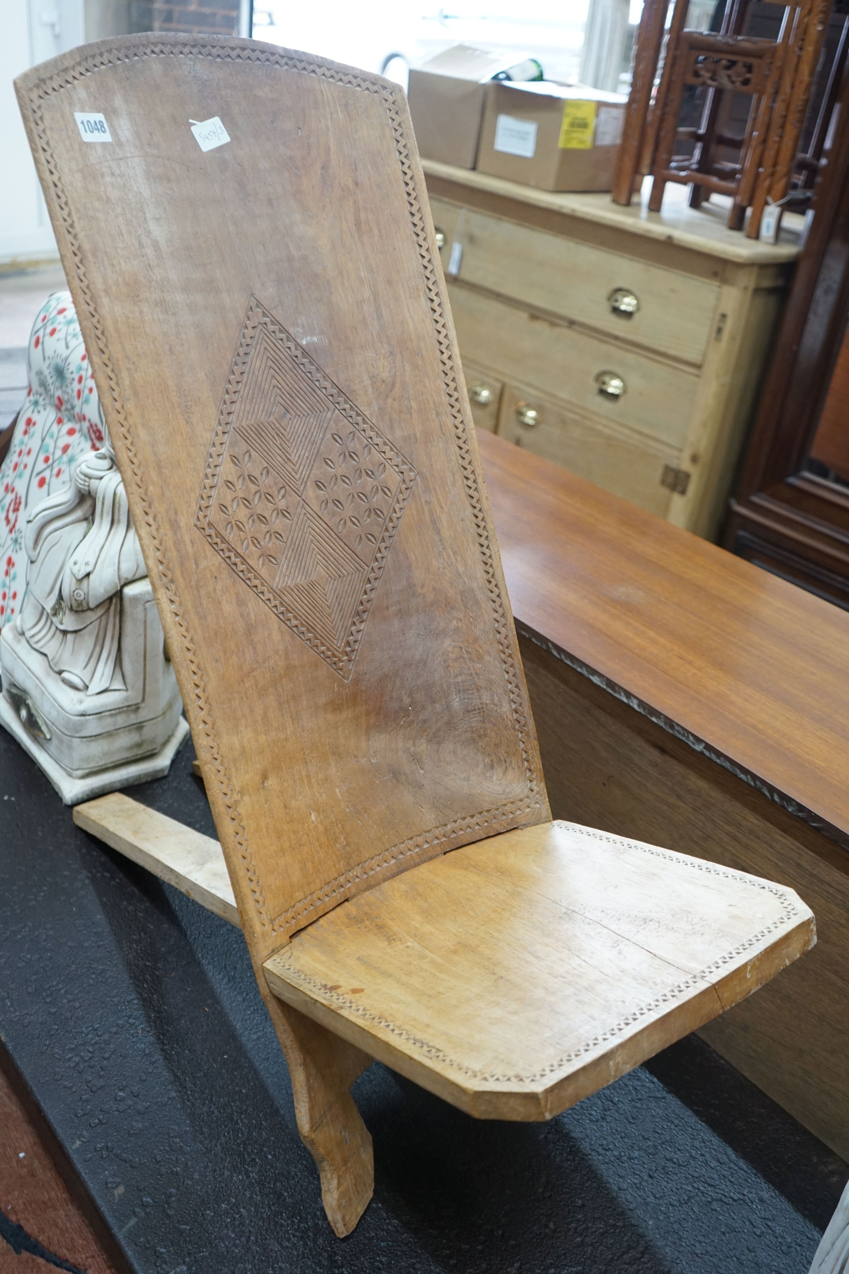 An African chip carved hardwood seat, height 90cm